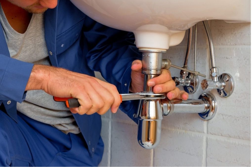 A Professional Plumber Fixing a Sink Drain | General Plumbing Services